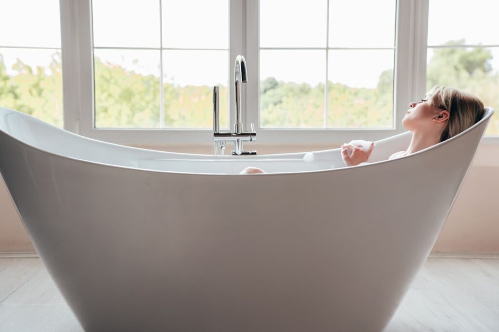 A woman relaxing in a bathtub.