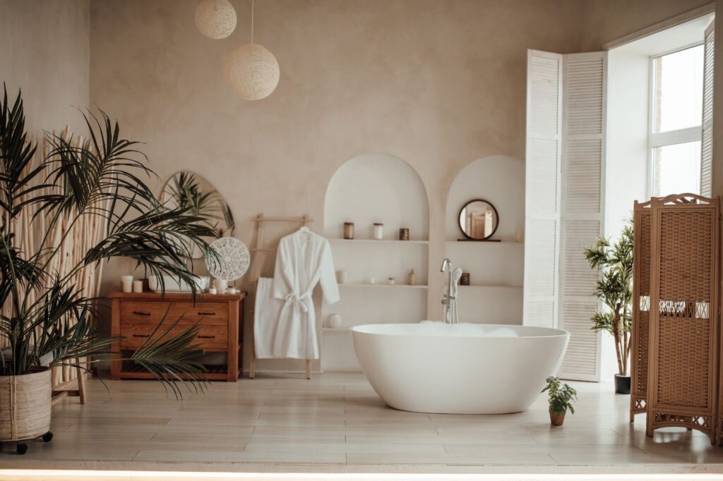 Luxurious and spacious bathroom in modern African-inspired style, featuring an oval bathtub bathed in natural light.